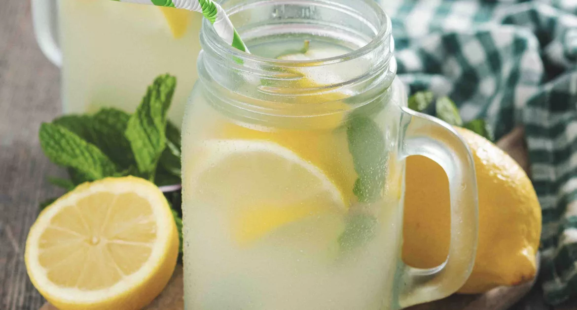 lemon water in a jar glass on wooden table