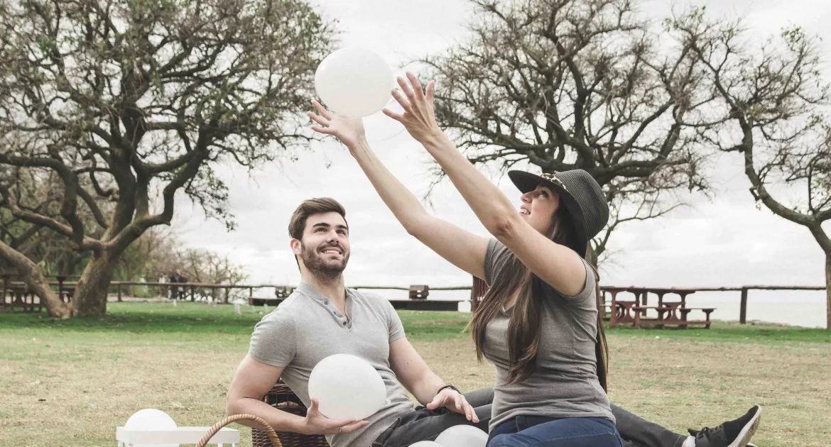 Two people enjoying a healthy outdoor picnic, showcasing a lifestyle tip for boosting immunity against cold and flu.